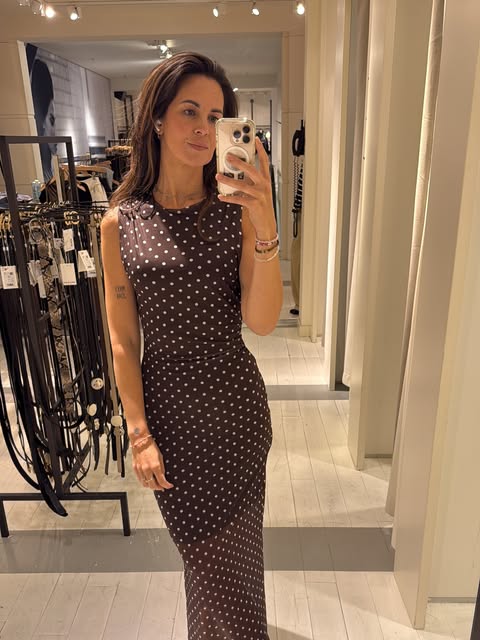 Saskia maakt een spiegelselfie in een gestippelde jurk